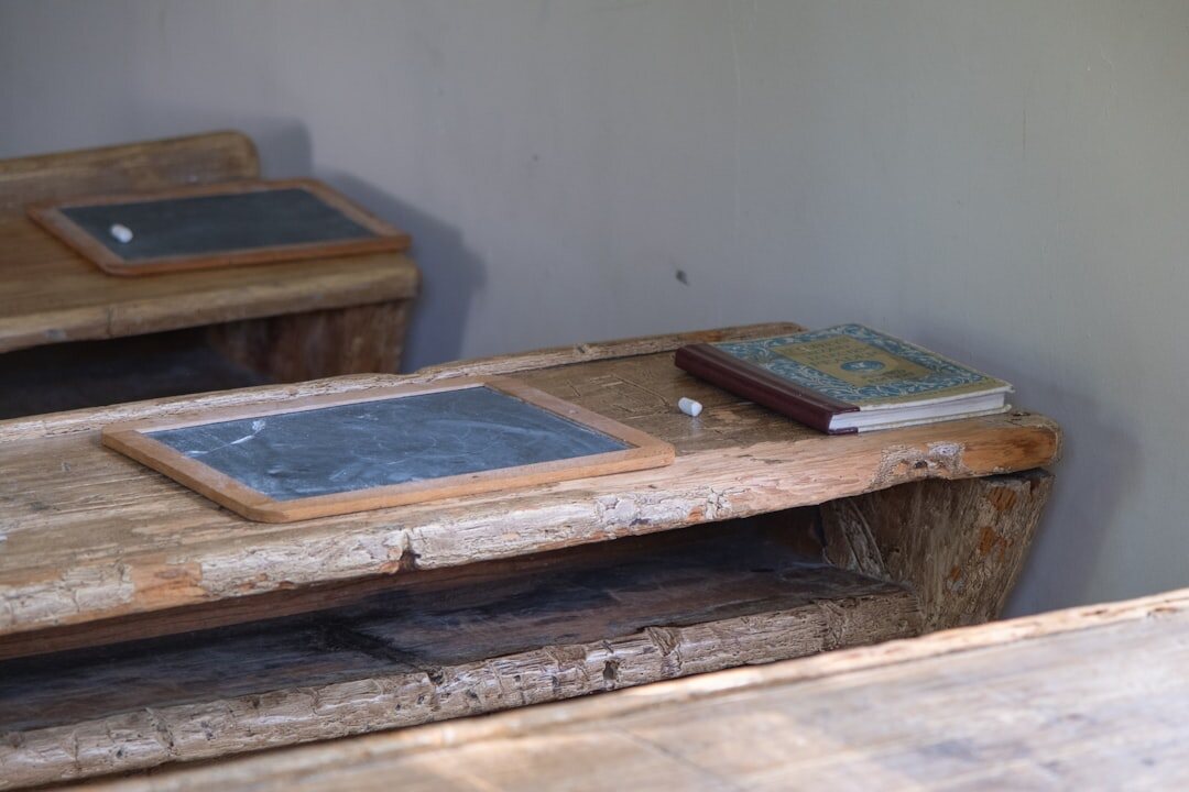 Old books and a magnifying glass on a wooden desk
