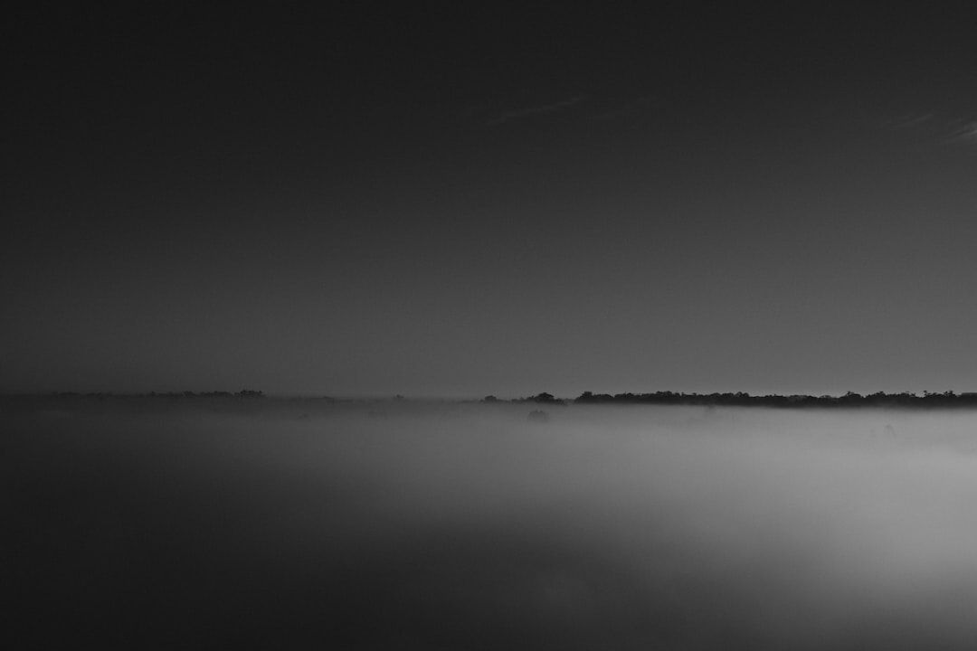 Silhouette of a person walking down a foggy street at night in Montevideo